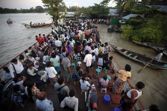 Passengers traveling on a government-owned ferry get ready to disembark at the Dallah township of Yangon, Sept. 18. Dallah Township, a short ferry ride cross the river, is the place where the big city touches the province. Thousands of daily migrants cross the river to Dallah using dangerous long tail boats and cheap government operated ferries.