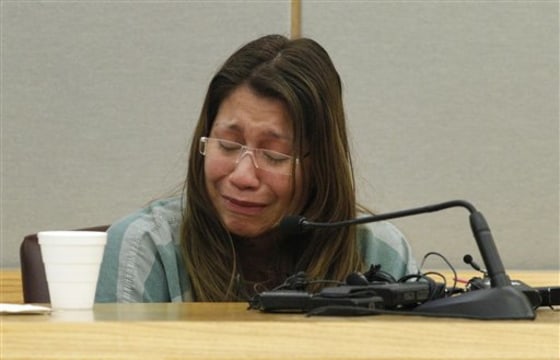 Elizabeth Escalona, 23, breaks down as she responds to a line of questions on Thursday in Dallas. Escalona admitted to beating her toddler and gluing her hands to a wall.