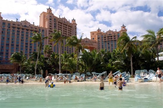 Guests at the Atlantis hotel swim on Paradise Island, Bahamas. The resort features one of the largest outdoor marine habitats in the world, one that showcases more than 50,000 aquatic animals representing 250 species.