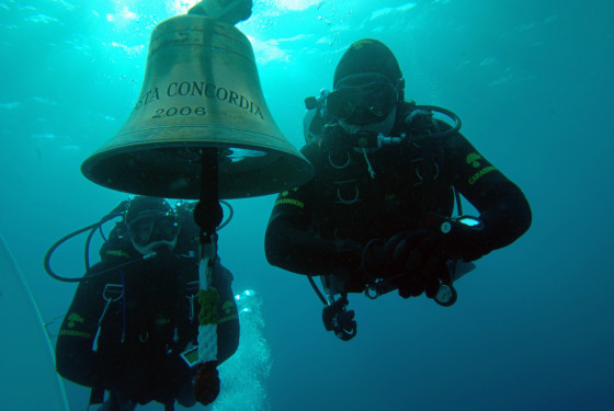 Carabinieri divers pass by the bell of the stricken Costa Concordia luxury liner near the Giglio island during searches on Jan. 19. Italian rescuers were forced to suspend operations on the stricken Costa Concordiaon on Jan. 20, a week after a Mediterranean tragedy in which up to 32 people are feared dead.