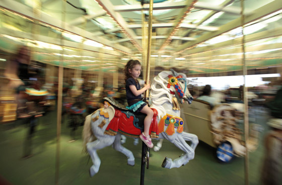 A girl rides the Looff Carousel at the Santa Cruz Beach Boardwalk in Santa Cruz, Calif., June 29. The carousel made its debut in August 1911, built by Charles I.D. Looff, a master woodcarver from Denmark. Looff had already made his name with his first complete carousel placed at Coney Island in New York. Back then, rides cost a nickel. Today, the carousel, which has been designated a National Historic Landmark, costs $3.00 a spin.