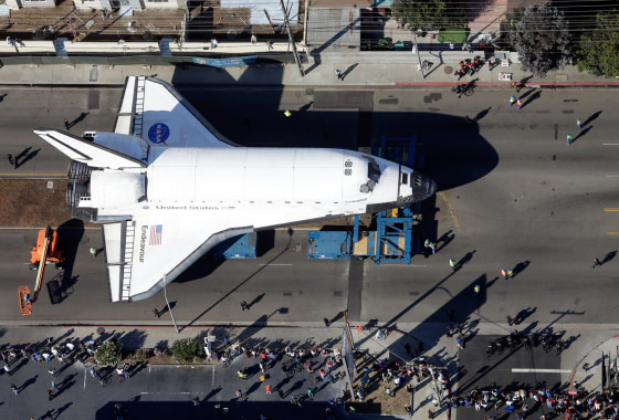 Spectators gather to watch the space shuttle Endeavour make its way down Manchester Blvd.