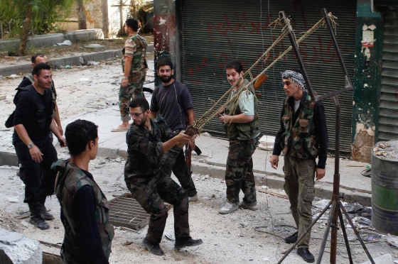 Members of the Free Syrian Army use a catapult to launch a homemade bomb during clashes with pro-government soldiers in the city of Aleppo, on Oct. 15.