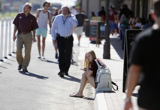Student Amy Hoeks waits for the Texas A&M campus to reopen while authorities investigate a bomb threat Friday, Oct. 19, 2012 in College Station, Texas.
