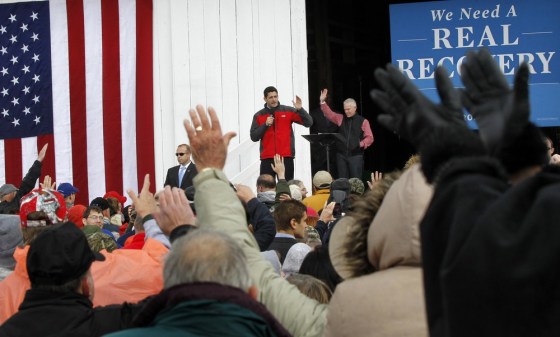 Republican vice presidential candidate, Rep. Paul Ryan, R-Wis. center, accompanied by Rep. Bill Johnson, R-Ohio, right, gestures Saturday while speaking at a campaign rally at the Valley View Campgrounds in Belmont, Ohio, where he talked about economic conditions and the coal industry.