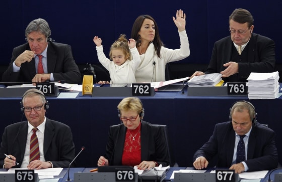 Italy's Member of the European Parliament Licia Ronzulli with her daughter Victoria takes part in a voting session at the European Parliament in Strasbourg, France on Oct. 23.