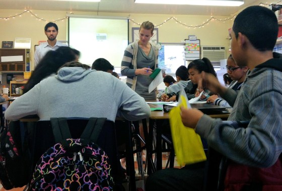 Amy Youngman, center, and Danny Shapiro, left, check student work during a middle school grammar lesson at ERES Academy in Oakland, Calif. Shaprio is a resident teacher-in-training and Youngman is his mentor.