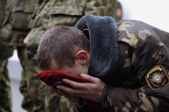 A serviceman from a special Interior Ministry receives a red beret after his test in Minsk, Belarus, Oct. 23.