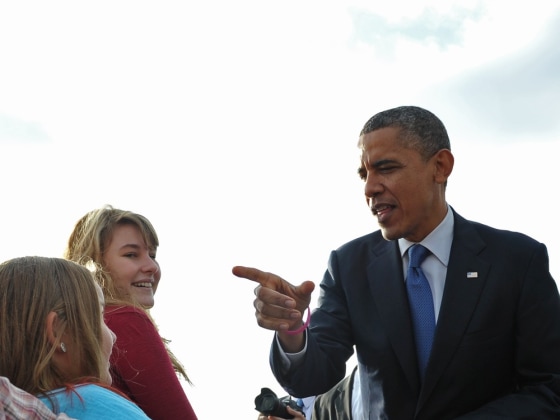 President Barack Obama chats with well-wishers October 24, 2012 upon arrival at Quad Cities International Airport in Moline, Illinois.