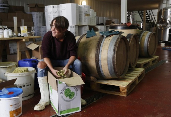London: Brewer Joby Williams breaks up the hops used in the brewing process to create an India Pale Ale beer at The Kernel micro-brewery.