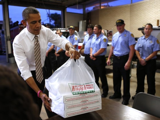 U.S. President Barack Obama delivers doughnuts to fire fighters at a fire house in Tampa, Florida October 25, 2012. Obama is on a two-day, eight-state campaign swing. REUTERS/Kevin Lamarque (UNITED STATES - Tags: POLITICS ELECTIONS USA PRESIDENTIAL ELECTION TPX IMAGES OF THE DAY)