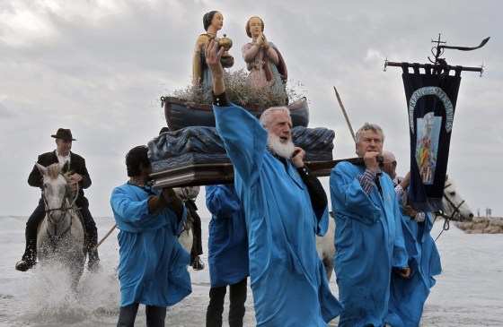 Pilgrims carry statues of Saint Mary Salome and Saint Mary Jacobe during a procession on a beach of Saintes-Maries-de-la-mer, southwestern France.