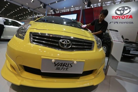 A worker cleans a Toyota Yaris car Oct. 12 at the Wuhan Motor Show, China's Hubei province. Although Toyota has outsold GM so far this year, the Japanese automaker's sales are falling in China over a territorial dispute.