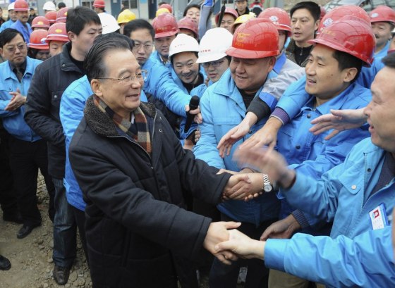 Chinese Premier Wen Jiabao shakes hands with local workers in earthquake-hit Mianzhu, Sichuan province in this Jan. 25, 2009 file photo.