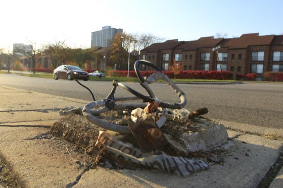 A broken streetlight base can be seen on a sidewalk east of downtown Detroit.