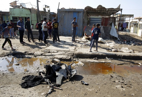 Residents inspect the site of a bomb attack in Baghdad Oct. 27, 2012. Two blasts hit a Baghdad Shi'ite neighborhood and a bus full of Iranian pilgrims on Saturday, killing at least 30 people on the second day of the Islamic Eid al Adha religious festival, police and hospital sources said.