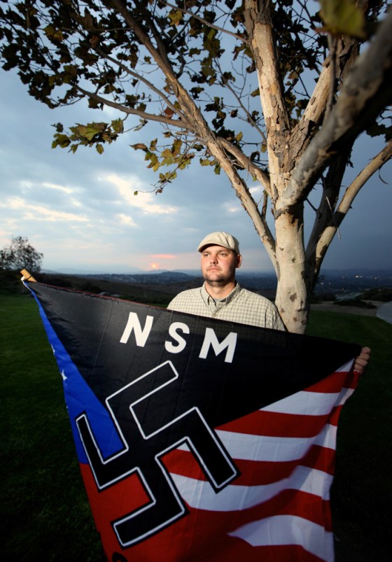 Jeff Hall holds a neo-Nazi flag near his home in Riverside, Calif., on Oct. 22, 2010. His son told police he pulled a .357-Magnum from a closet and aimed it at Hall's ear and pulled the trigger before running upstairs and hiding the weapon, according to court papers.