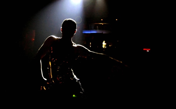 Teddy, a Lebanese university graduate, performs a belly dance at a nightclub in Beirut, in this 3 November 2007 file picture.