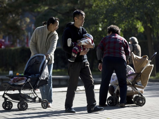 Chinese families bring their babies to the Ritan Park in Beijing Wednesday, Oct. 31, 2012. A government think tank says China should start phasing out its one-child policy immediately and allow two children for every family by 2015. It remains unclear whether Chinese leaders are ready to take that step.
