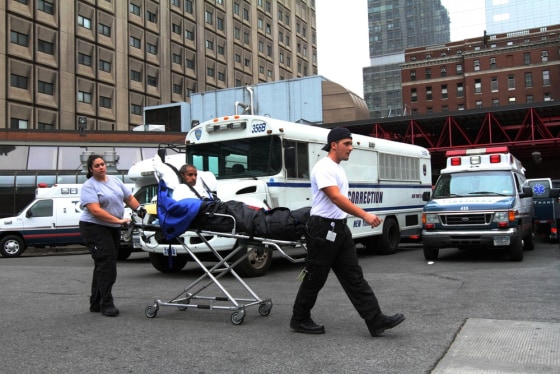 A patient is taken to a waiting medical transport vehicle outside Bellevue Hospital in New York on Wednesday.