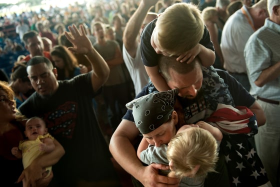 People pray during the 'Charlotte 714' prayer service at the Verizon Wireless Amphitheatre, Sept. 2, in Charlotte, N.C. The group gathered to celebrate and reinforce Christian values during the week of the Democratic National Convention.