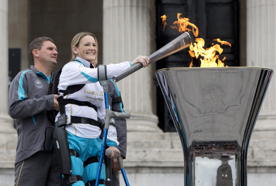 Claire Lomas stands on robotic legs to light the Paralympic cauldron at Trafalgar Square in London, Aug. 24, 2012.