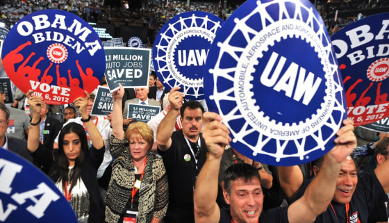 Supporters wave signs during President of the International Union, United Automobile, Aerospace and Agricultural Implement Workers of America (UAW) Bob King 's address at the Time Warner Cable Arena in Charlotte, North Carolina, on September 5, 2012 on the second day of the Democratic National Convention.