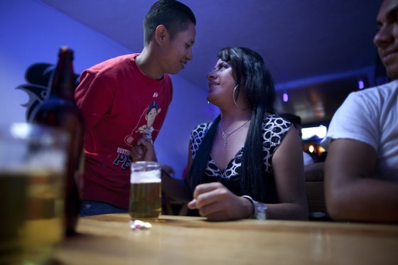 Linda Elizabeth Tylor Martinez flirts with a potential client at a bar in the