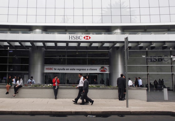 Pedestrians walk past the entrance of British bank HSBC's headquarters in Mexico City in July.