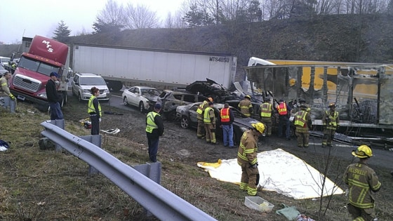 Rescue workers look over the scene on I-77 where 95 vehicles were involved in an accident in Carroll County, Virginia near the North Carolina state line on Sunday.