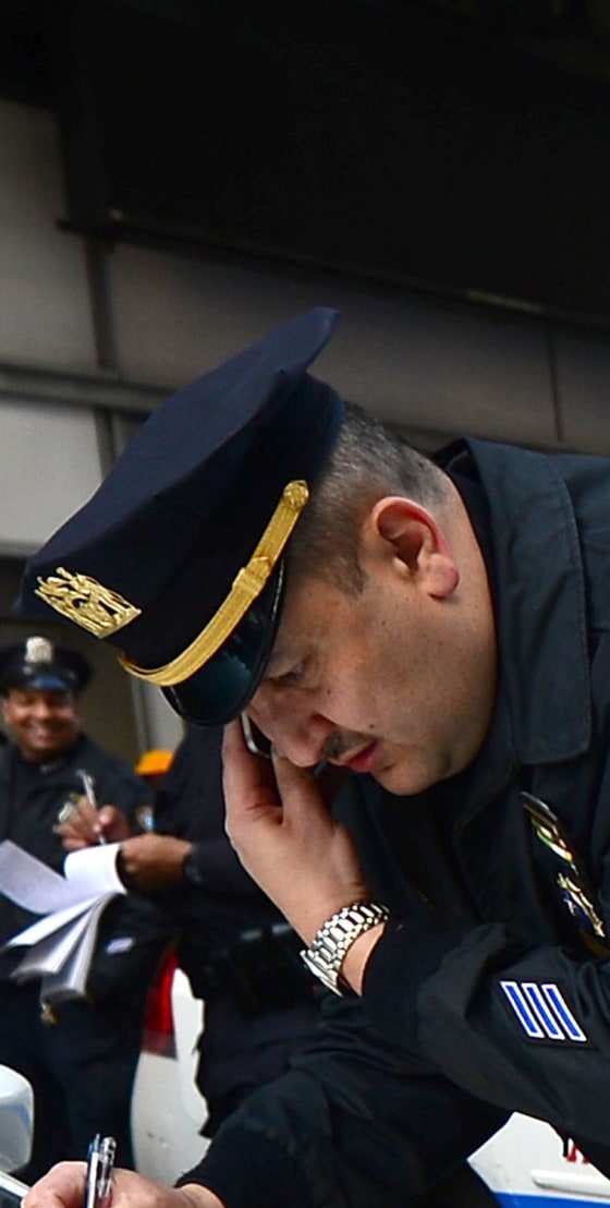 Policemen man their post at New York's Times Square after security was boosted following blasts that occured at the finish line of the Boston marathon...