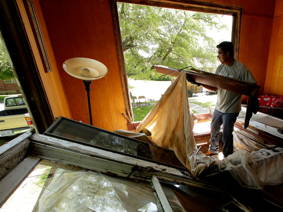 Five days after a fertilizer plant explosion, volunteer Albert Saenz, from China Spring, Texas, clears debris from a home belonging to Ray and Patti Rosales on April 22, in West, Texas.