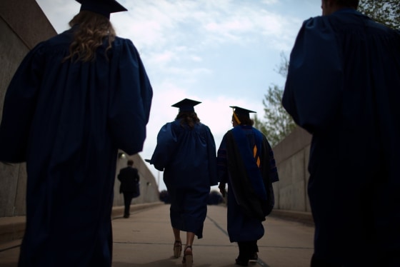 Alumni of the University of Illinois at Urbana-Champaign school of business emerge from a tunnel of the State Farm Center after participating in comme...