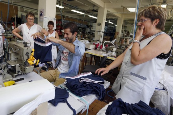 Guillaume Gibault, 27, center, founder and designer of Le Slip Francais men's underwear brand, works on a sample. Gibault offers a