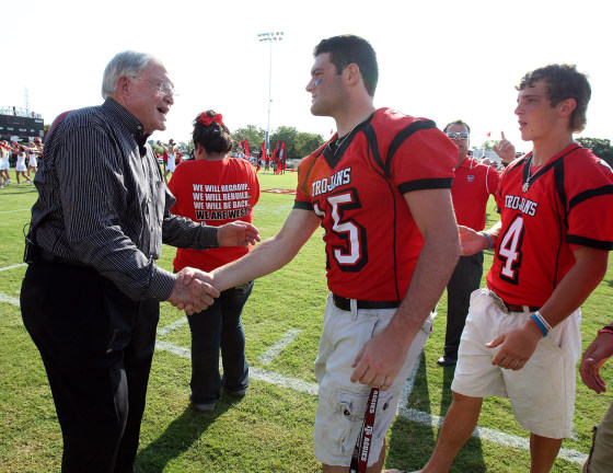 Former Baylor football coach Grant Teaff greets West Trojans football player Tyler Pustejovsky and his teammates on Aug. 29, at a morning pep rally in West, Texas. The West Trojans open the season Thursday night on their field that was used as a triage site when West Fertilizer Plant exploded on April 17, where 15 people died.