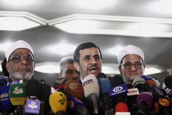 Ahmadinejad speaks to the media flanked by two Sheikhs of the Al Azhar mosque during a press conference in Cairo Tuesday.