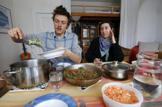 Raphael Fellmer, a supporter of the foodsharing movement has lunch with his partner Nieves Palmer Muntaner, with food cooked from vegetables from waste of an organic supermarket in Berlin, on Jan. 24.