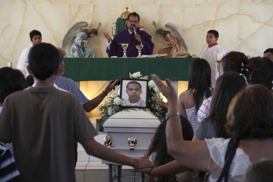Relatives pray beside a coffin containing the body of 16-year-old Jose Antonio Elena Rodriguez during his funeral in Nogales, Mexico, on Oct. 14. A U.S. Border Patrol agent fired at suspected drug smugglers across the border into Mexico late Oct. 10, and the teen was hit seven times, an autopsy showed.
