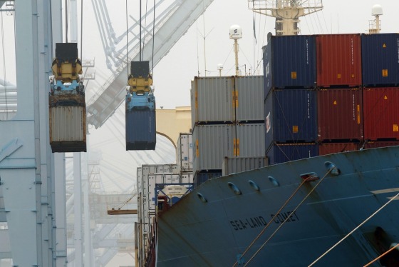 In this Wednesday, Dec. 5, 2012 file photo, containers are unloaded from cargo ships at APM Terminals in the Port of Los Angeles.