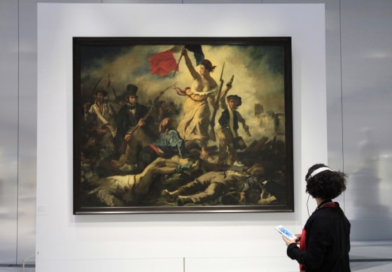 A woman looks at Eugene Delacroix 's painting,