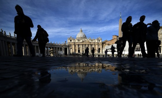 Tourists and the faithful walk on St Peter's Square at the Vatican on Tuesday. The Catholic Church entered uncharted waters after Pope Benedict XVI's shock announcement that he would become the first pontiff to resign in more than 700 years.