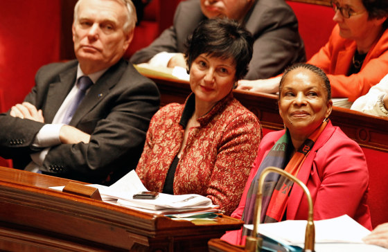 French justice minister Christiane Taubira, right, sits on the government bench with social affairs minister Dominique Bertinotti, center, and prime minister Jean Marc Ayrault, during the vote at the National Assembly in Paris, Tuesday Feb. 12, 2013, of a new law legalizing gay marriage. France's lower house of parliament has approved a sweeping bill to legalize gay marriage and allow same-sex couples to adopt children.