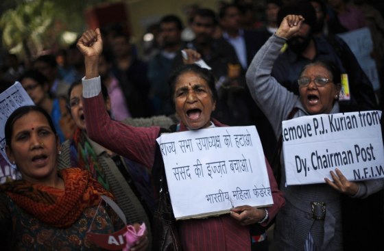 Protesters near the Indian parliament Thursday complain that a new sexual violence law is inadequate. Their signs call for the removal of the deputy chairman of the parliament's upper house, P.J. Kurien, who is facing rape allegations.