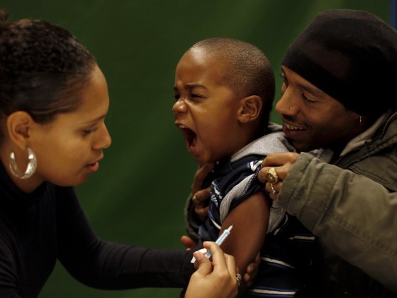 A young child is vaccinated against the H1N1 flu virus in 2009. A new report says the US childhood vaccine schedule is safe.