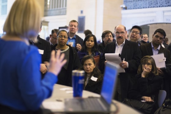 Job seekers listen to a social media expert during a job fair in New York, January 10, 2013.