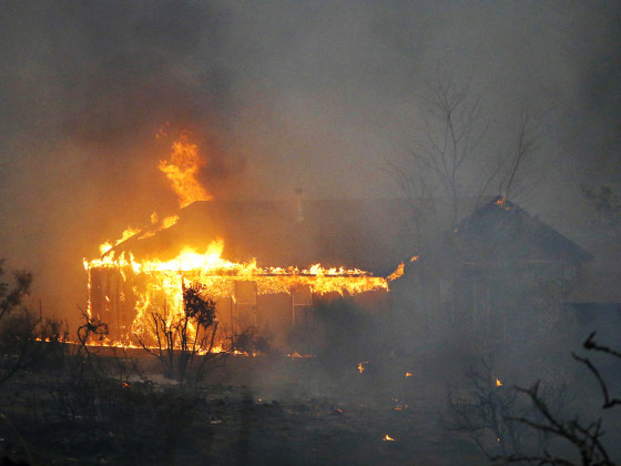 Homes burn as the Yarnell Hill Fire approaches Glenn Ilah on Sunday, June 30, 2013 near Yarnell, Ariz.