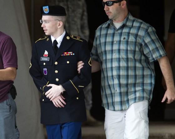 Army Pfc. Bradley Manning, is escorted out of a courthouse in Fort Meade, Md., Friday, June 28, 2013, after the start of the fourth week of his court martial.