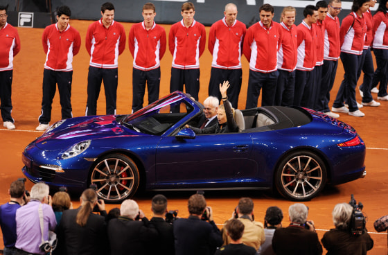 Maria Sharapova from Russia, right, and CEO of Porsche AG, Matthias Mueller drive in a Porsche 911 Carrera 4S Cabriolet during the victory ceremony af...