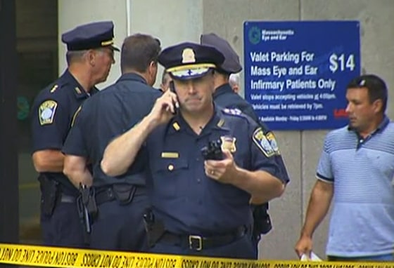 Police officers stand outside Massachusetts Eye and Ear Infirmary in Boston on Wednesday.