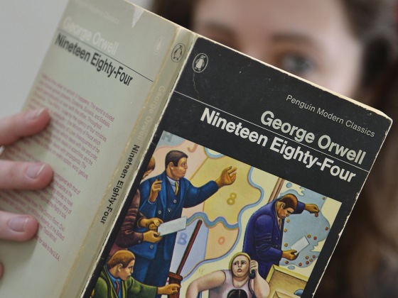 Laura Wood of Skoob Books poses for a photograph with a copy of George Orwell's '1984' in central London June 9, 2013. The novel, which is set in a w...